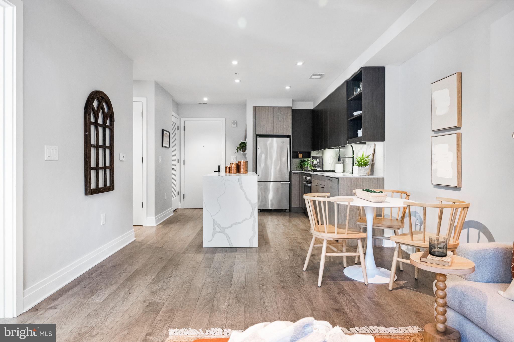 a dining room with furniture and wooden floor