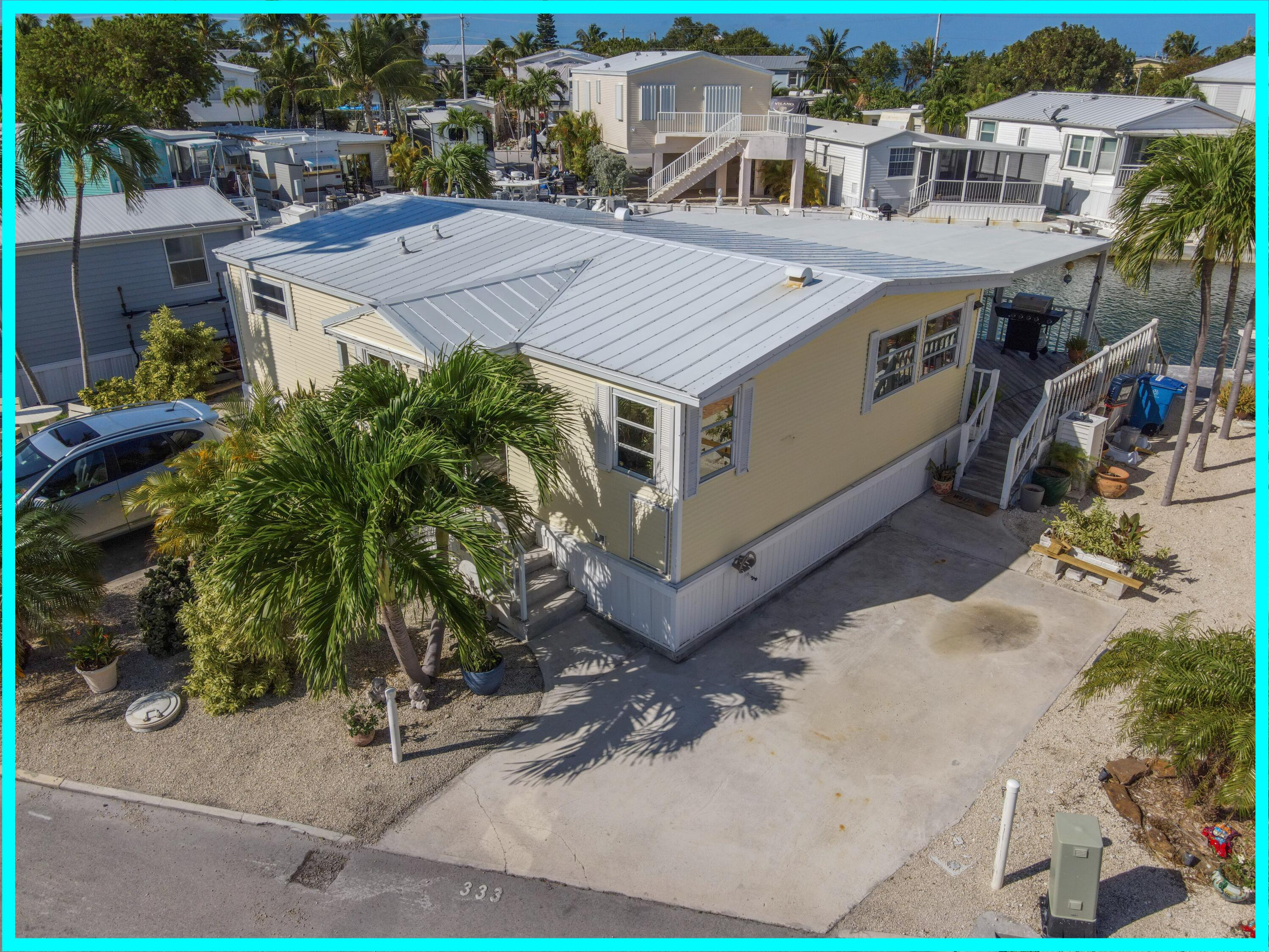 an aerial view of a house with a yard and balcony