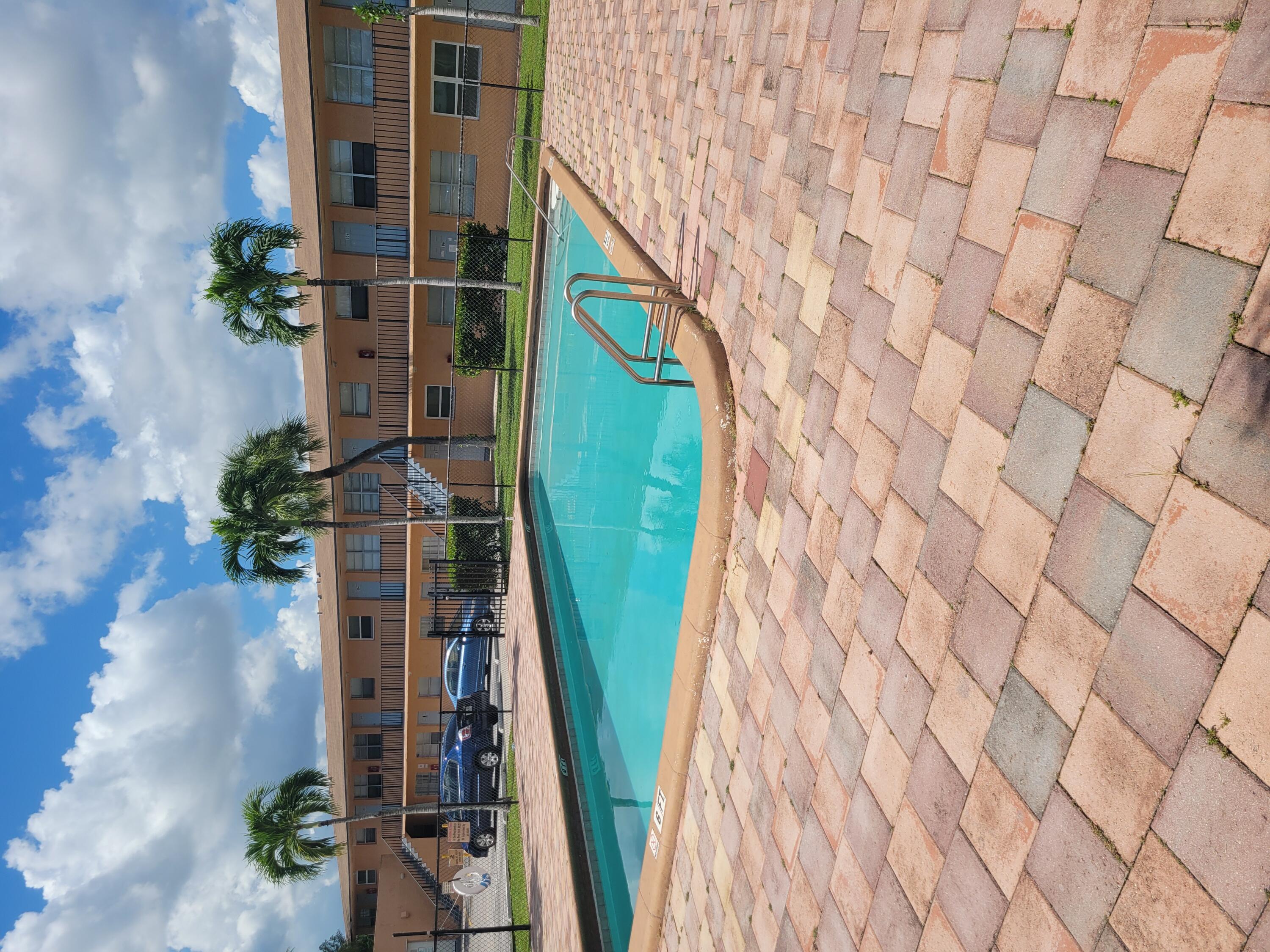 an aerial view of a house with swimming pool and sitting area