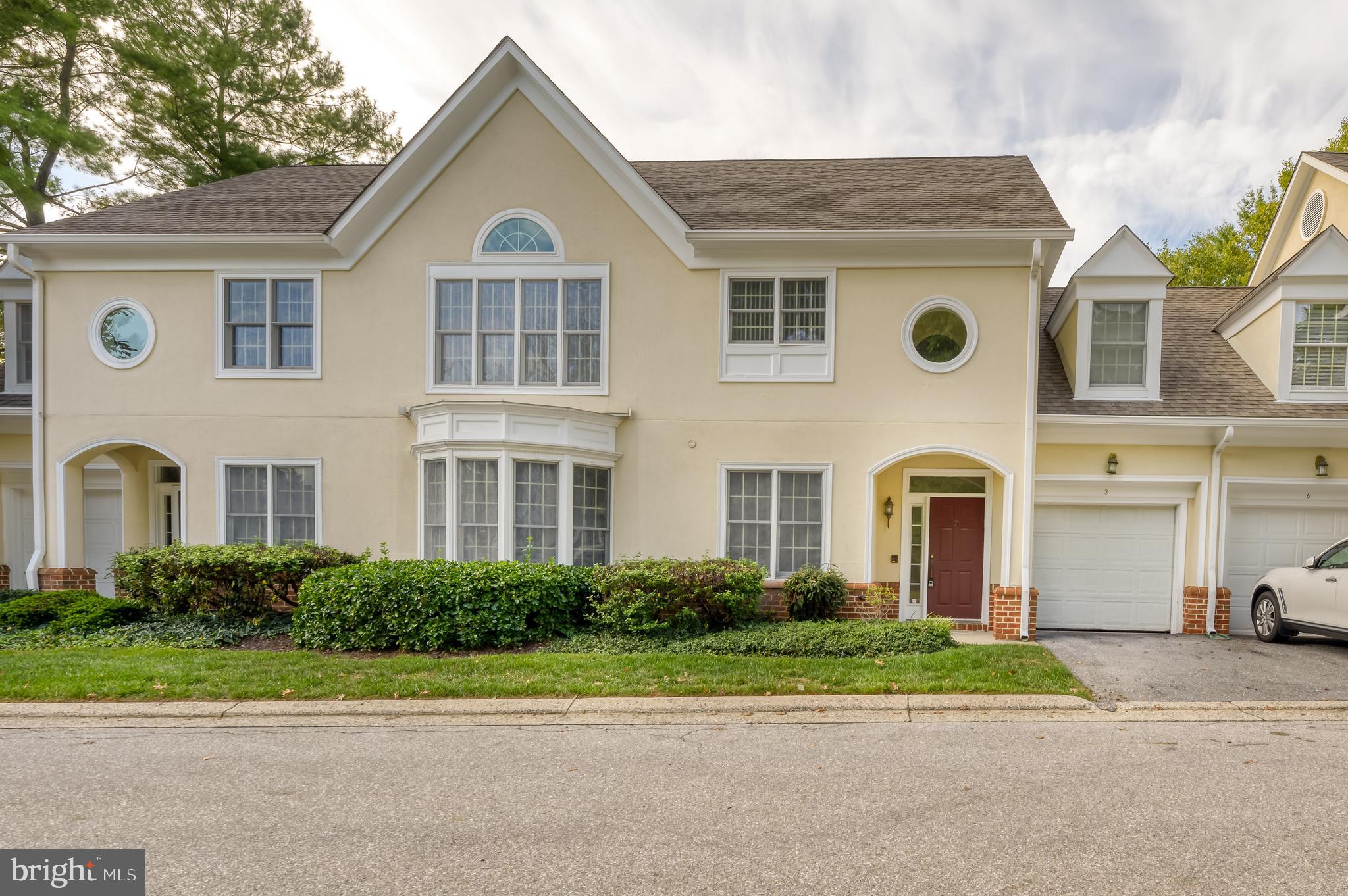 a front view of a house with a yard and a garage