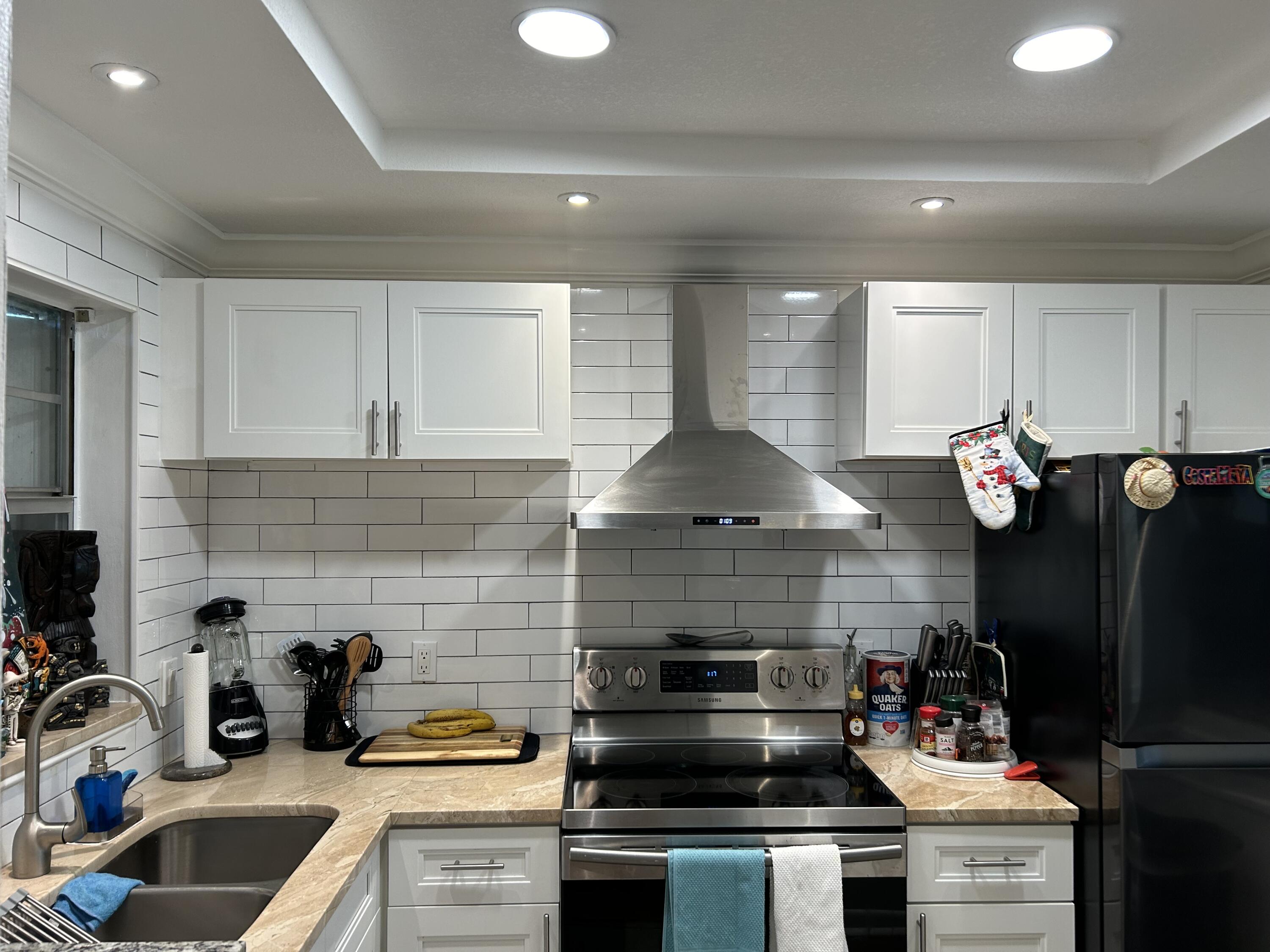 a kitchen with a stove and a refrigerator