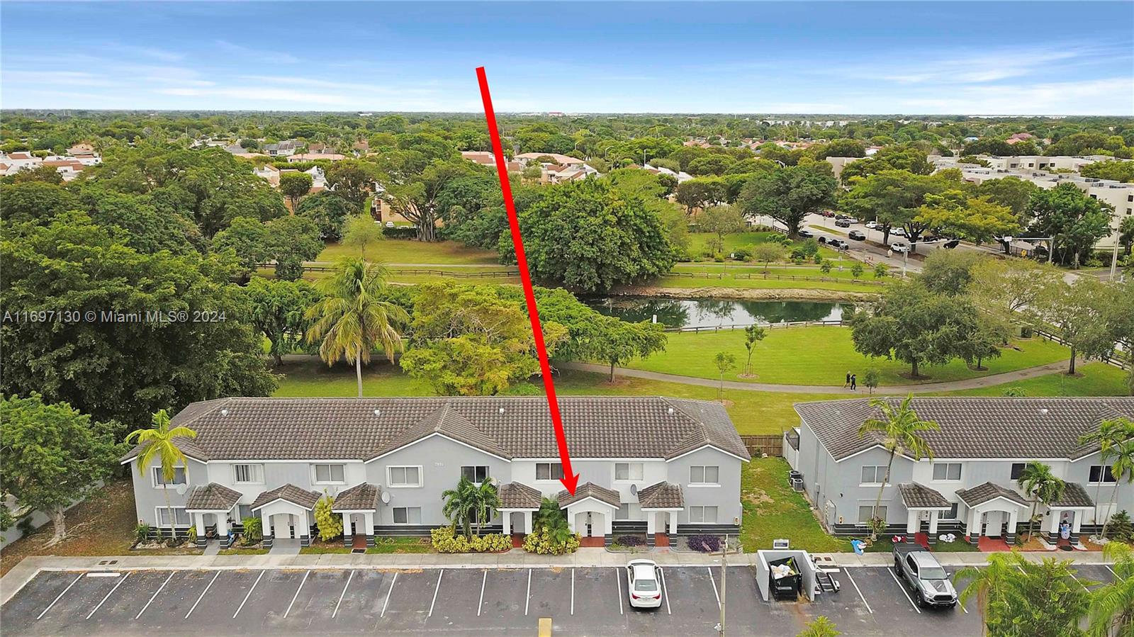 an aerial view of residential houses with outdoor space and swimming pool