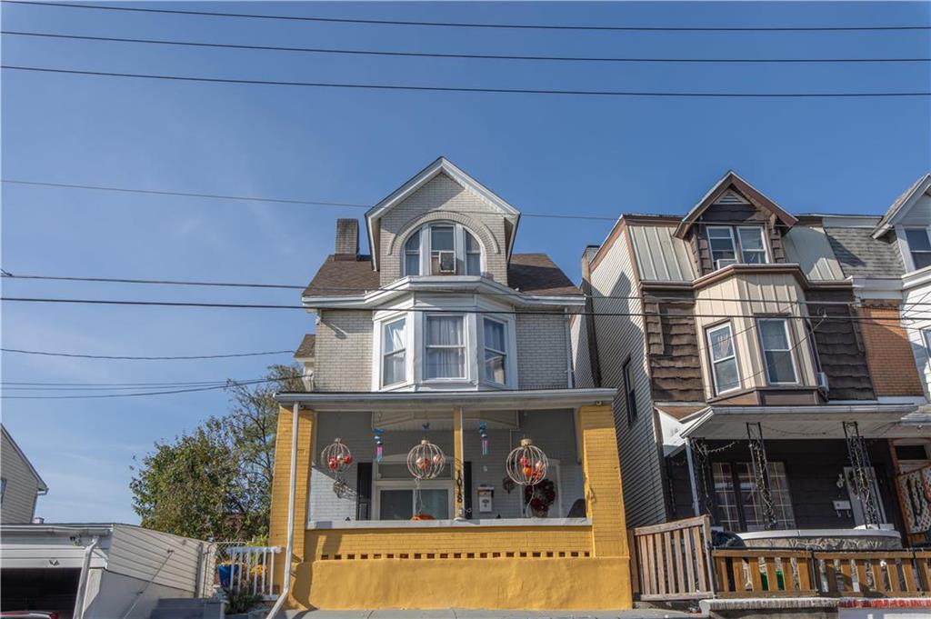 a front view of a house with lots of windows