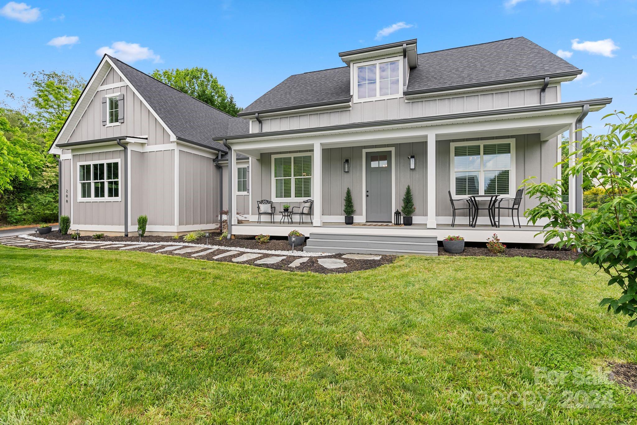 a view of a house with backyard sitting area and garden