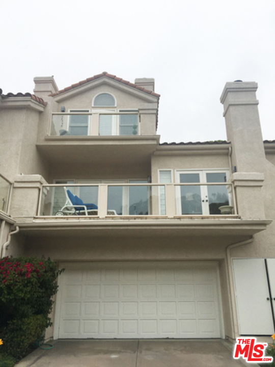 a front view of a house with parking space