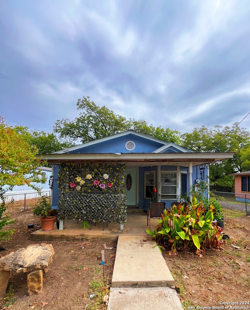 a front view of house with a garden