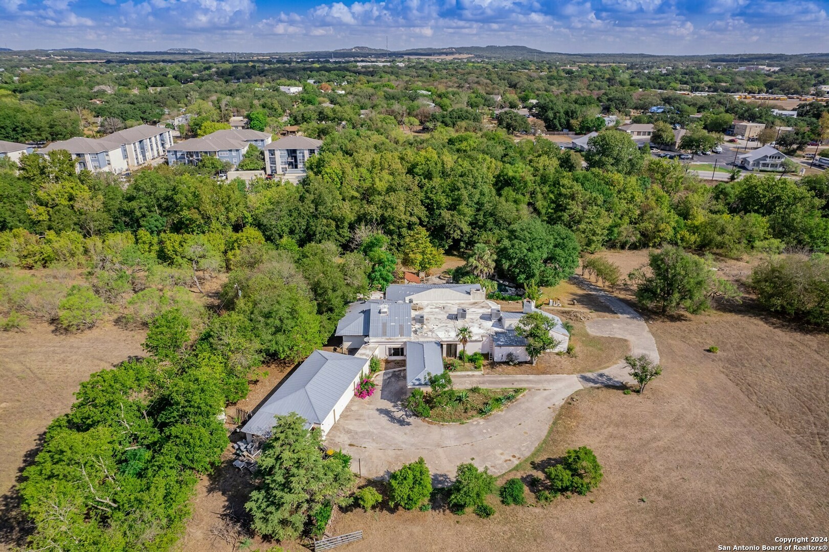 an aerial view of a house with a yard