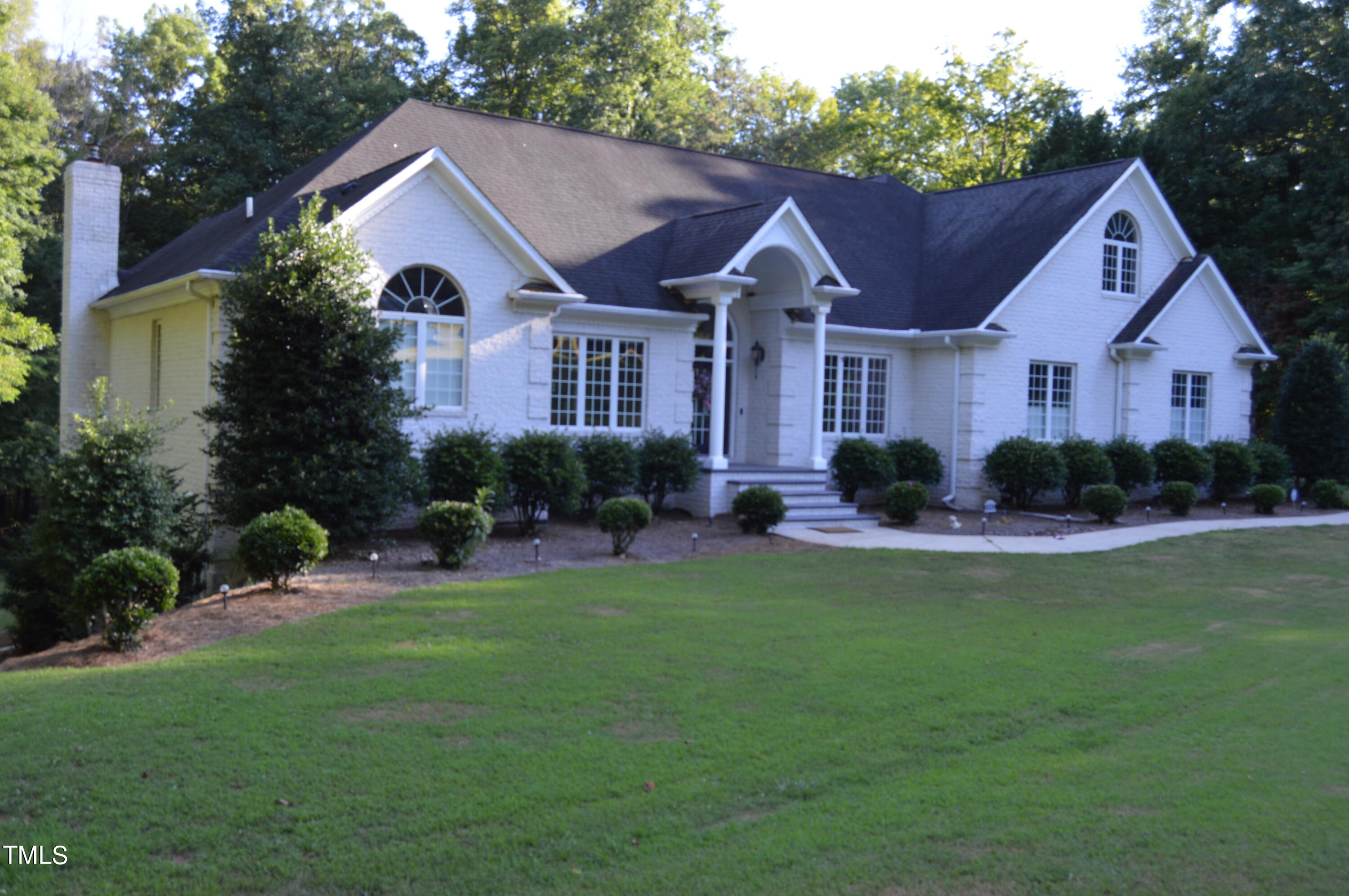 a front view of a house with a yard and porch