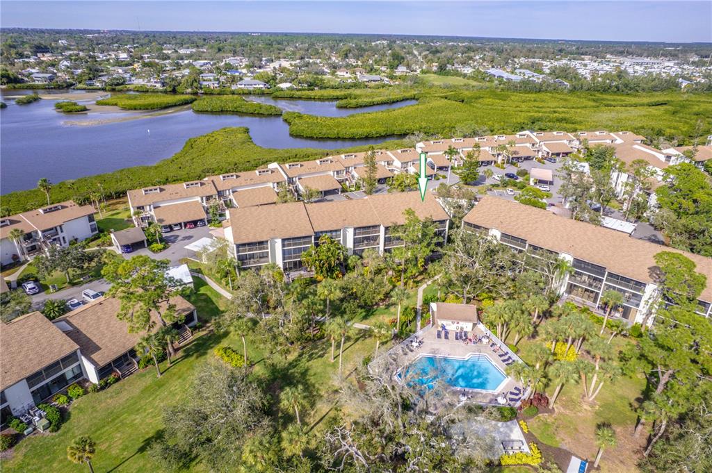 an aerial view of residential building with outdoor space lake view and an ocean view