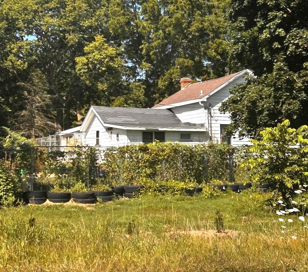 a front view of a house with a garden