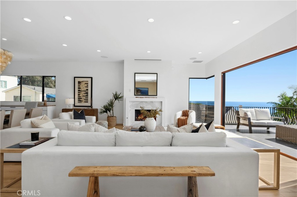 a living room with fireplace furniture and a large window