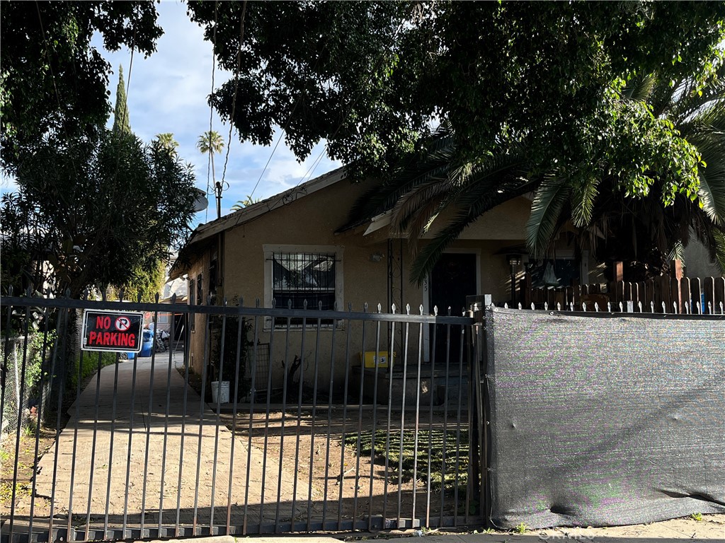 a view of a house with a wooden fence