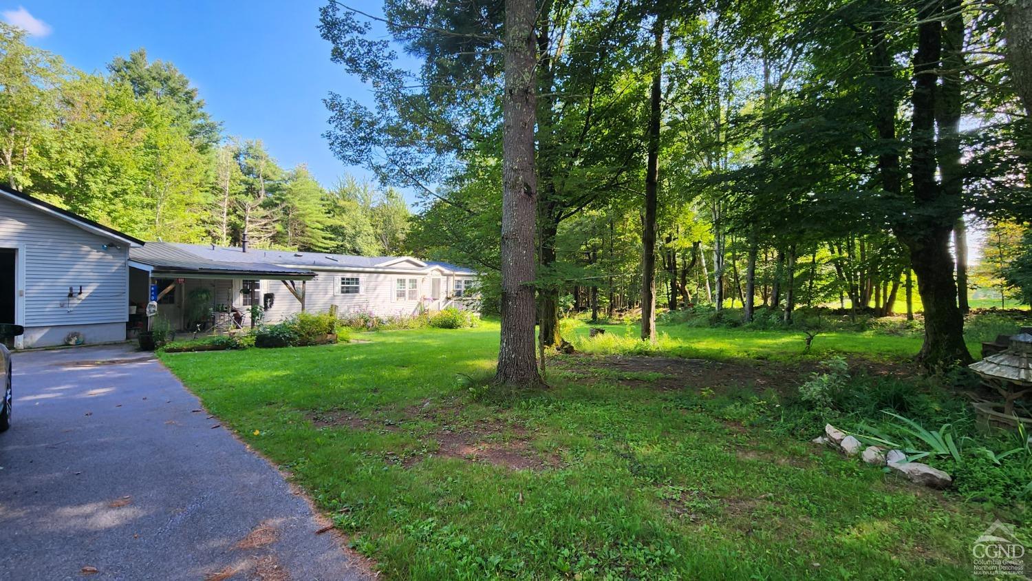 a view of a house with yard and tree s