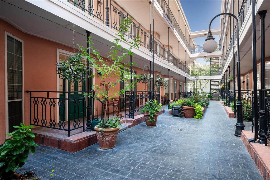 a view of a patio with potted plants and a fountain