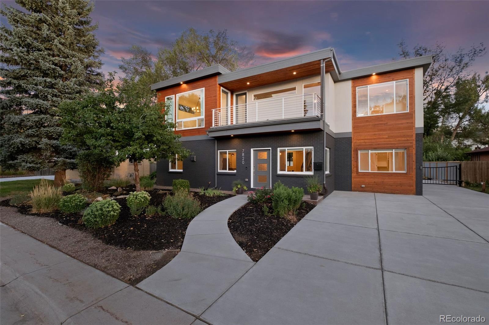 a front view of a house with yard and green space