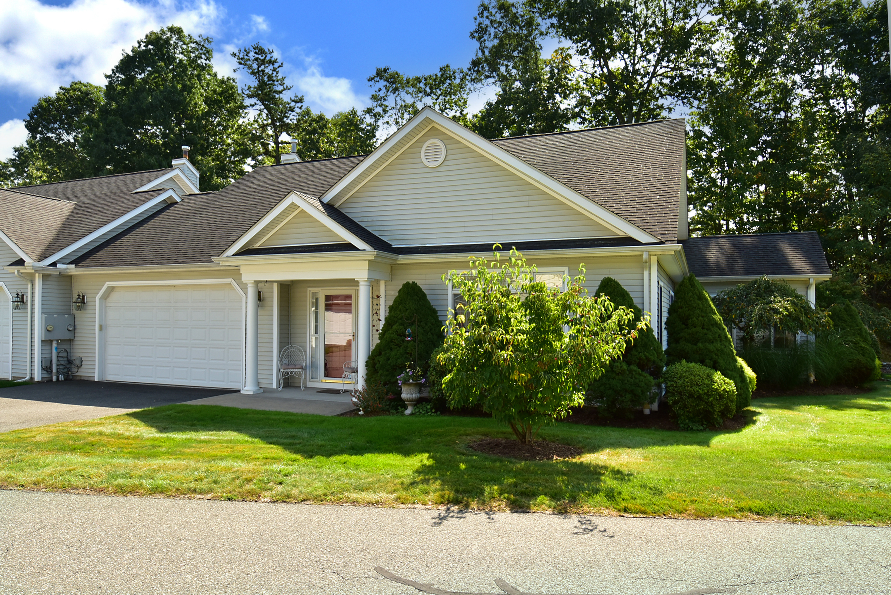 a front view of a house with garden