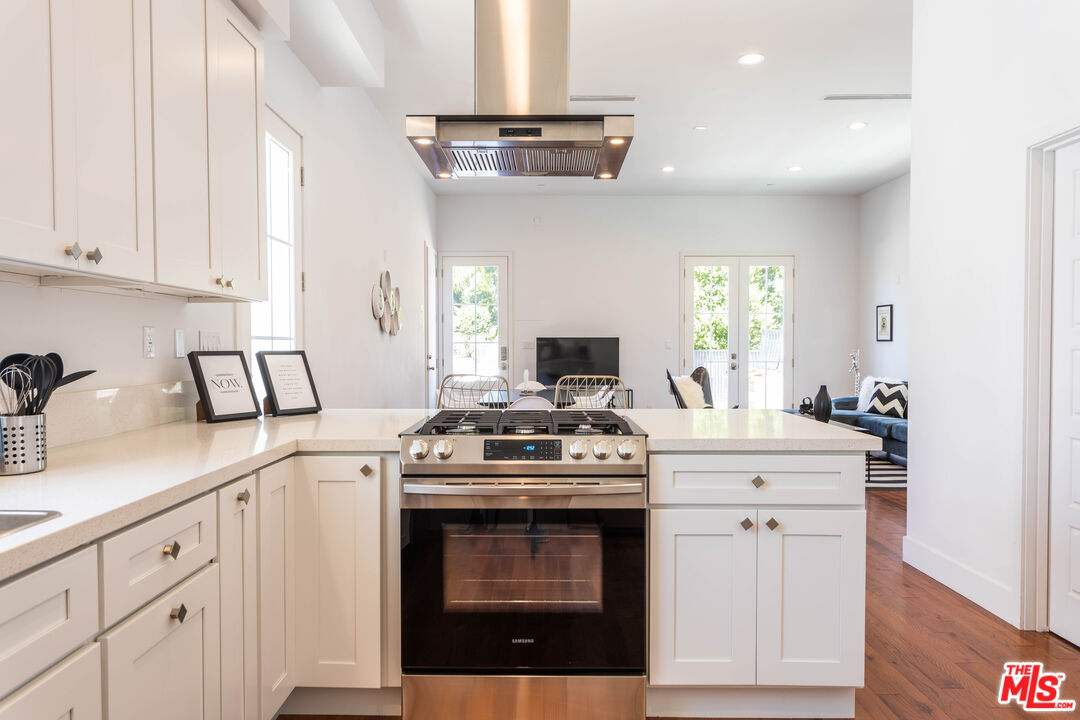 a kitchen with cabinets appliances a sink and a window