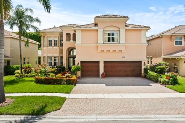 a front view of a house with a yard and garage