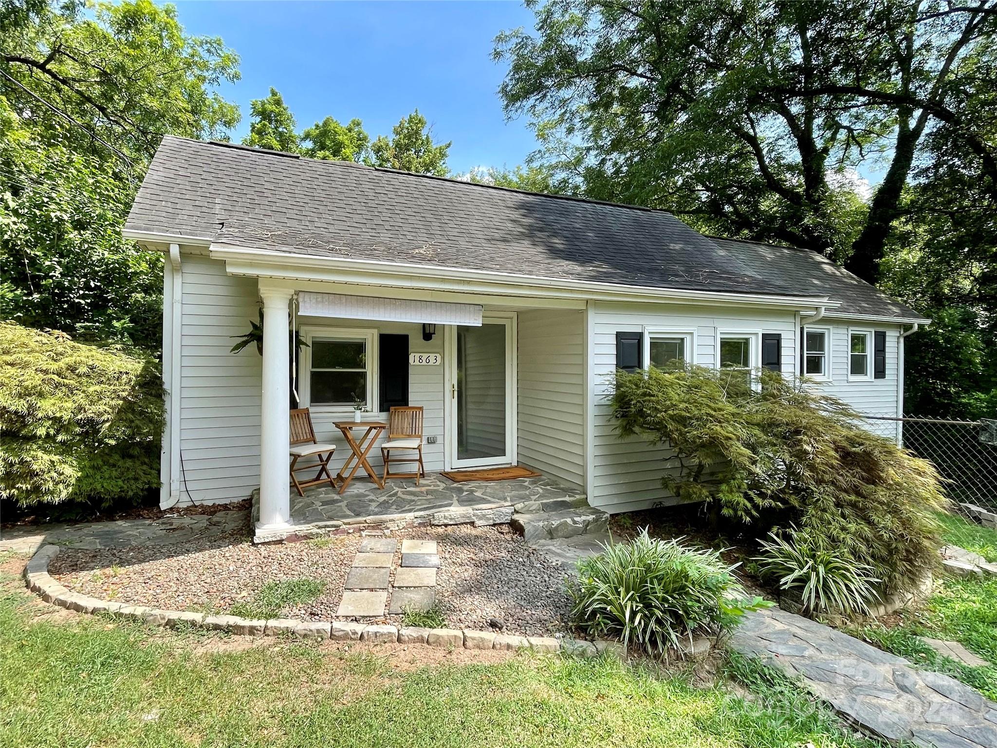 a front view of a house with yard outdoor seating and barbeque oven