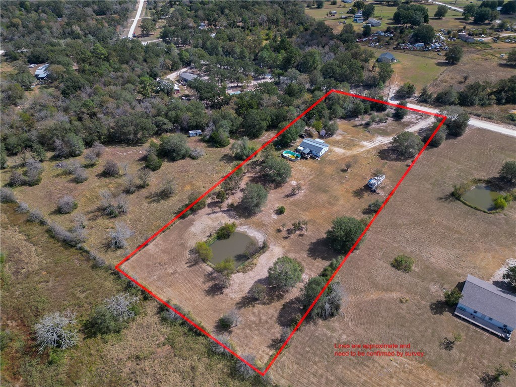 an aerial view of a houses with a yard