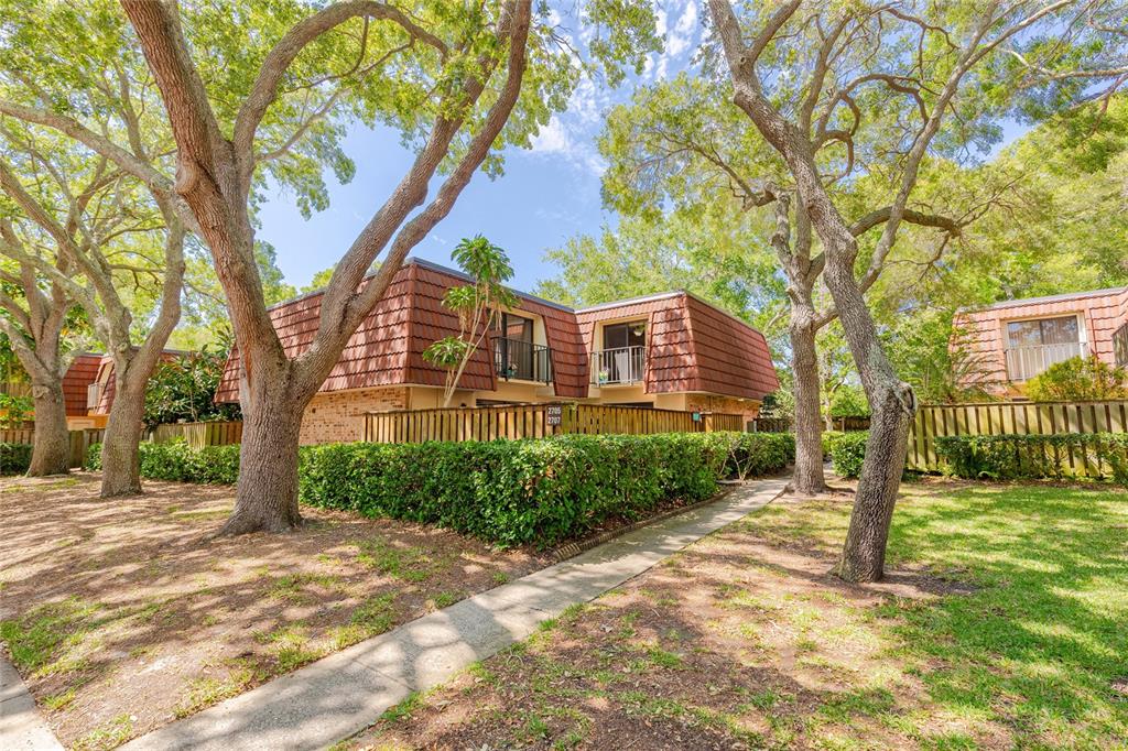 a front view of a house with a tree in the background