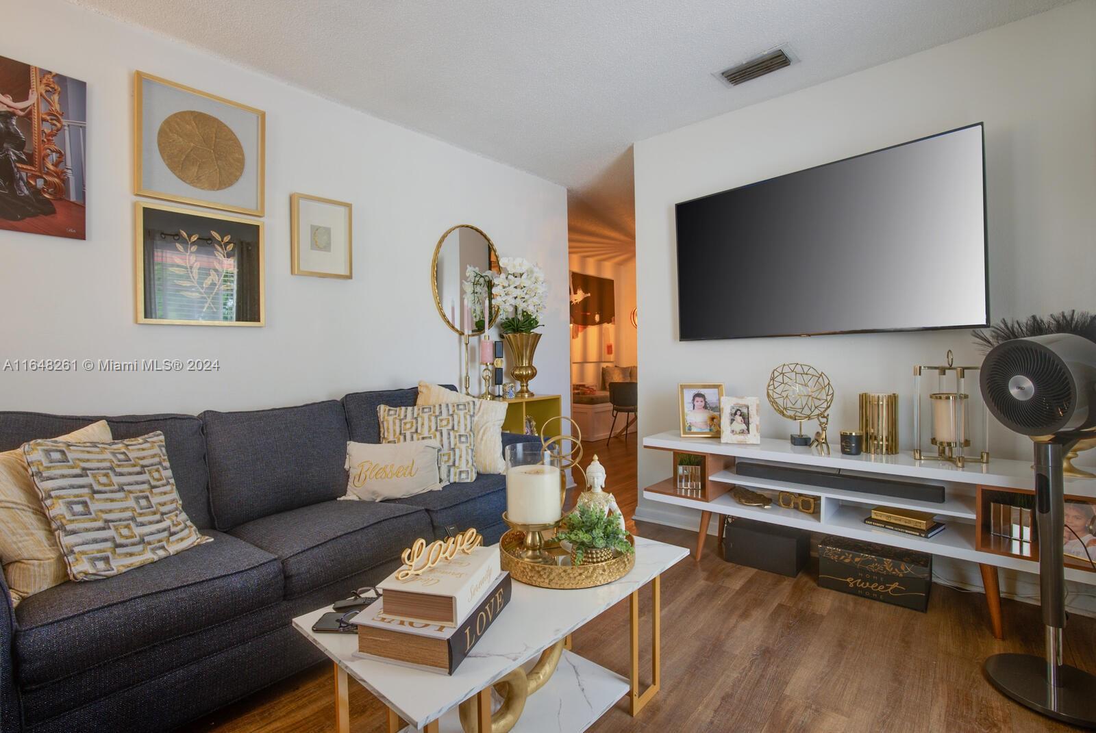 a living room with furniture and a flat screen tv