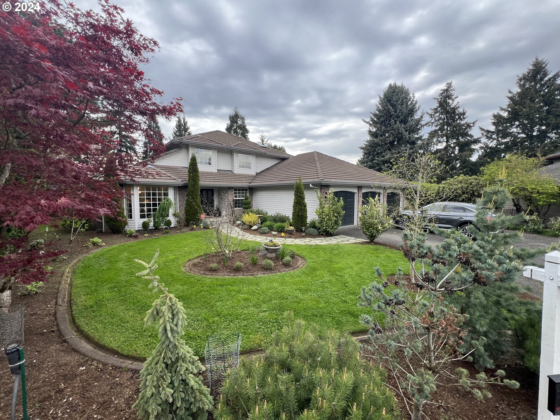 a front view of a house with garden