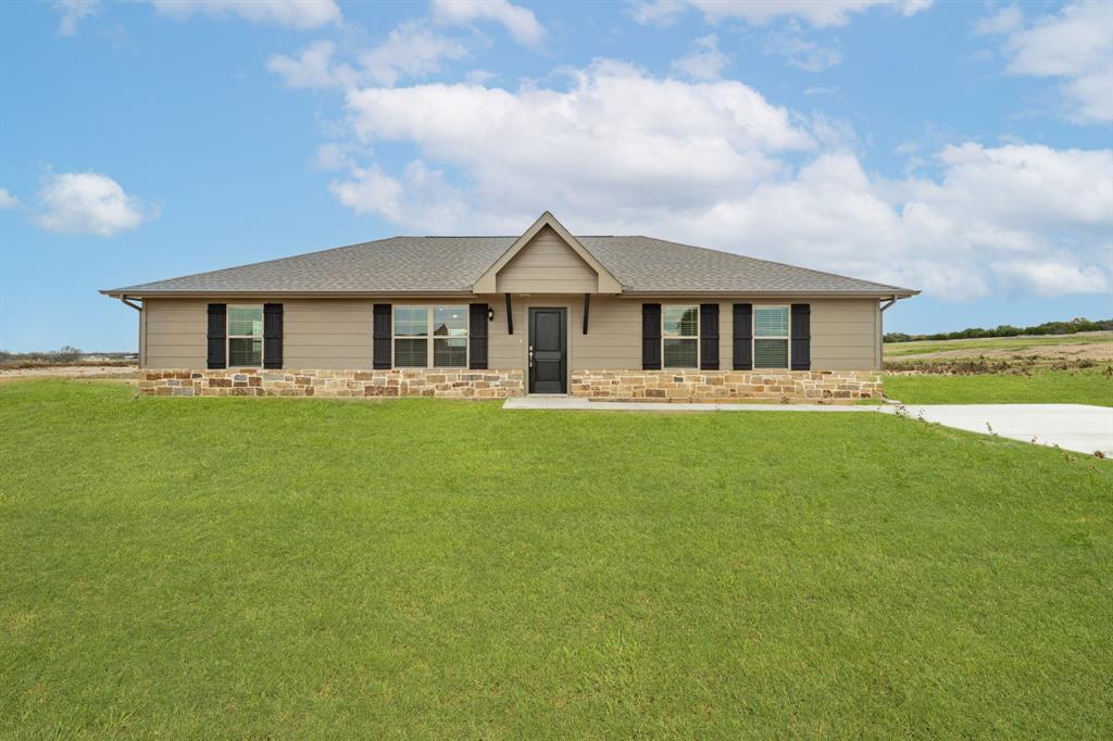 a front view of house with yard and green space