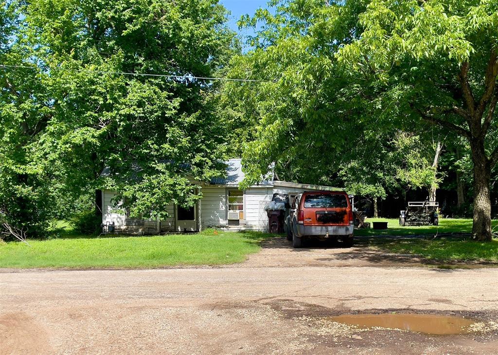 a car parked in front of a house with a yard