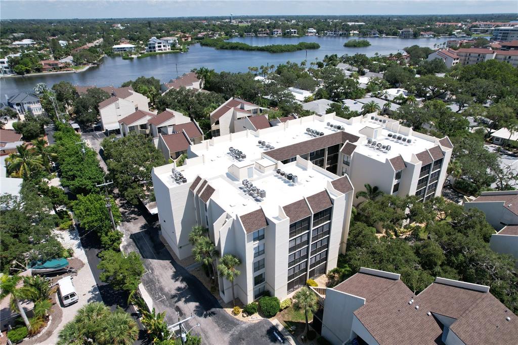 an aerial view of a house with outdoor space and lake view in back