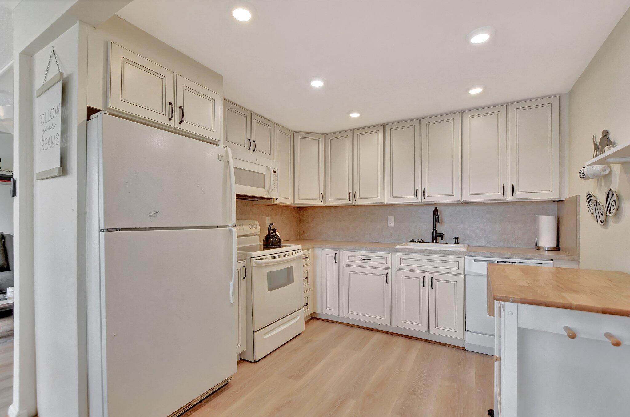 a kitchen with cabinets a refrigerator and a sink