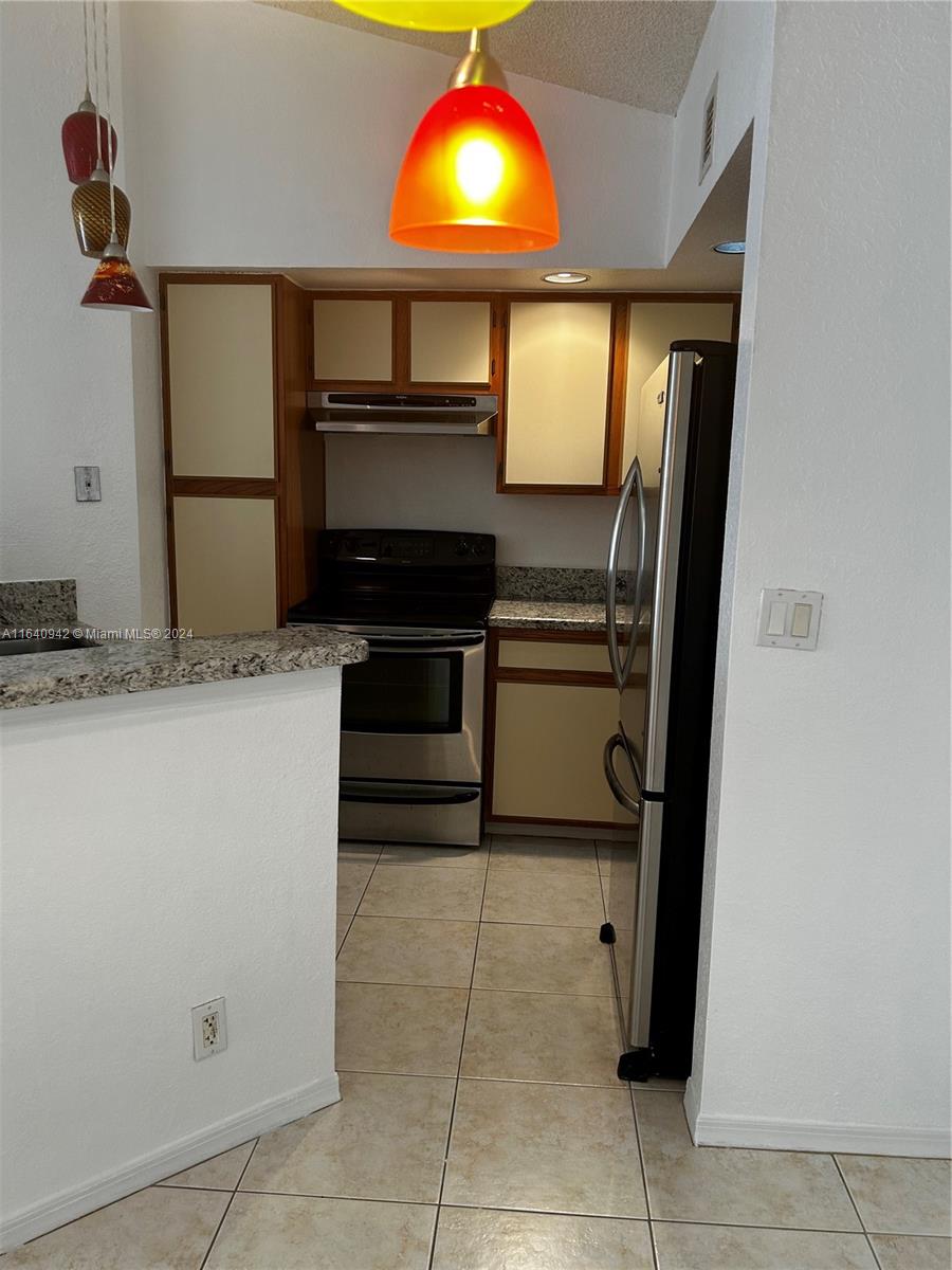 a kitchen with a sink and a refrigerator