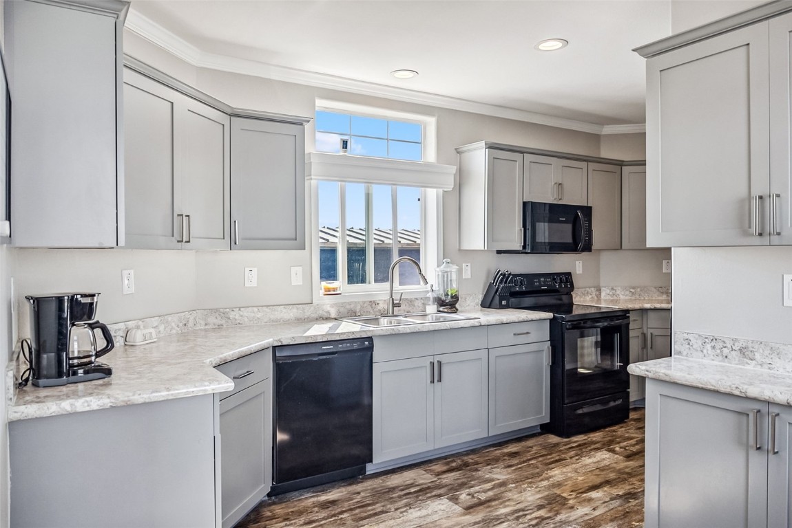 a kitchen with a sink stove and cabinets