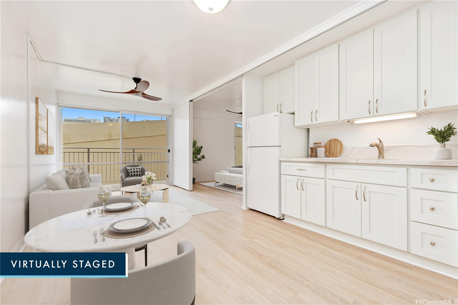 a kitchen with kitchen island sink stove and white cabinets