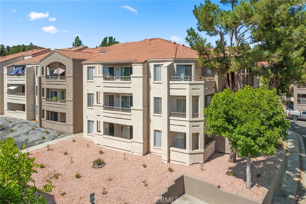 a front view of a residential apartment building with a yard