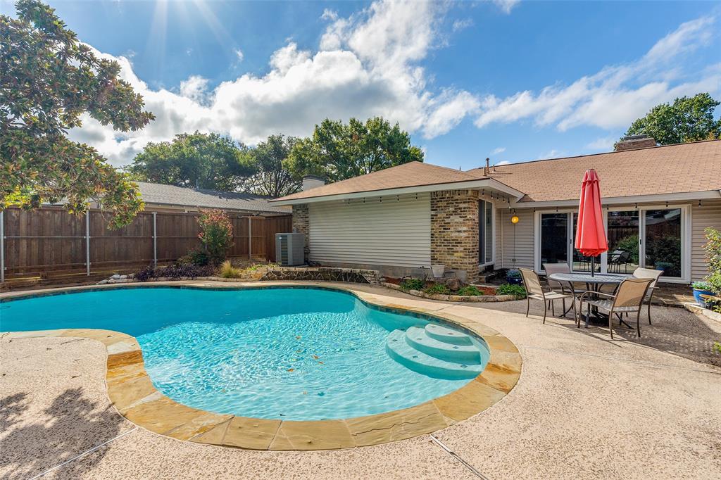 a view of a house with swimming pool and sitting area