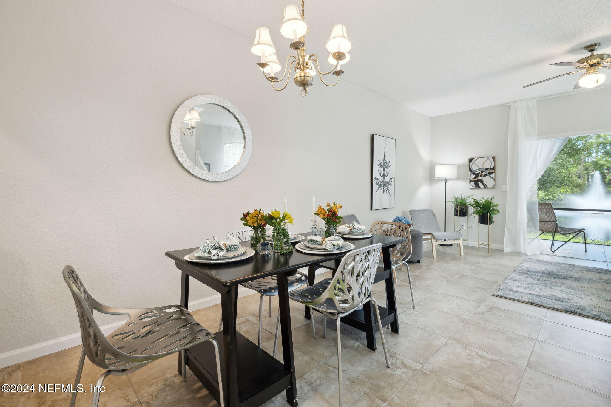 a view of a dining room with furniture and chandelier