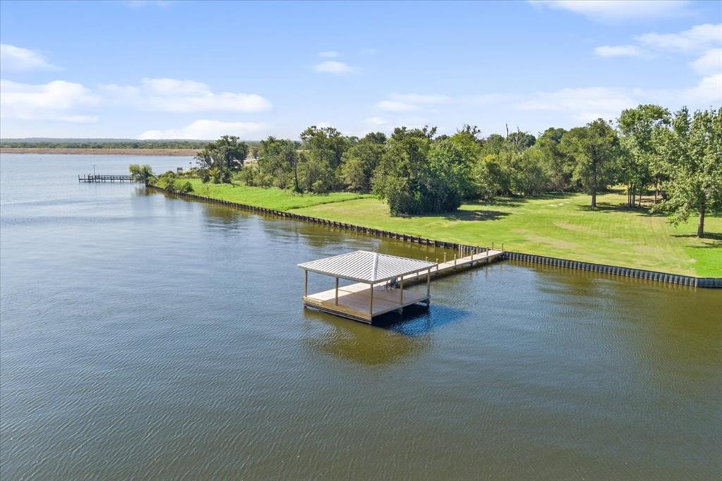 a view of a lake with lawn chairs