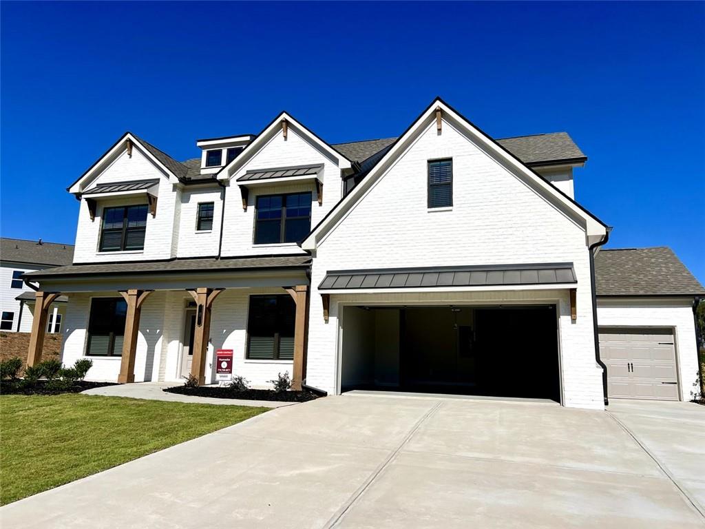 a front view of a house with yard and parking