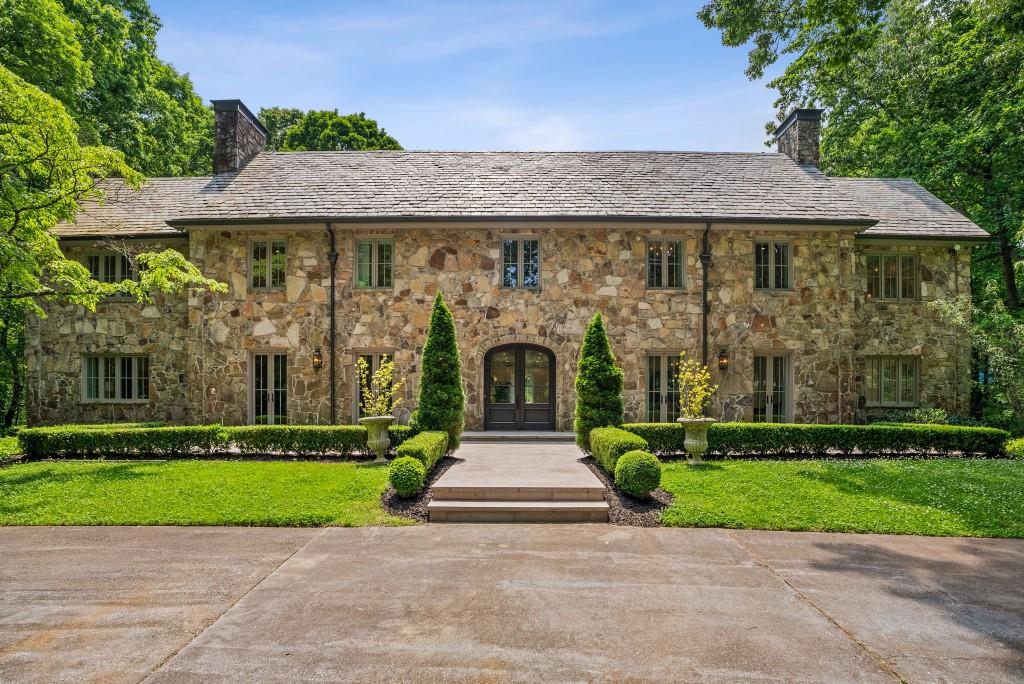 a front view of a house with a garden