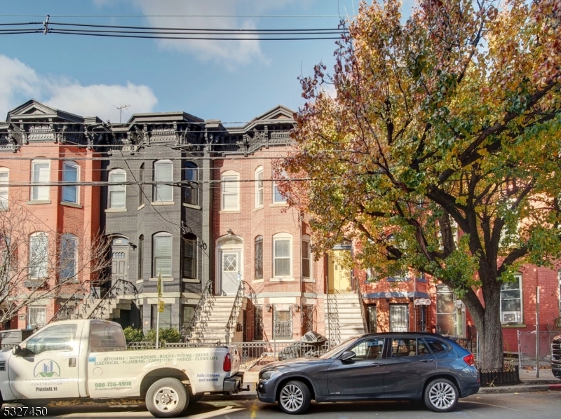 a front view of a residential apartment building with a parking space