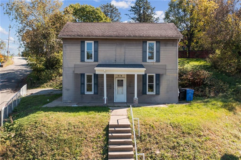 a front view of a house with a yard