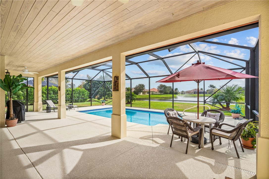 a view of yard with a table and chairs under an umbrella