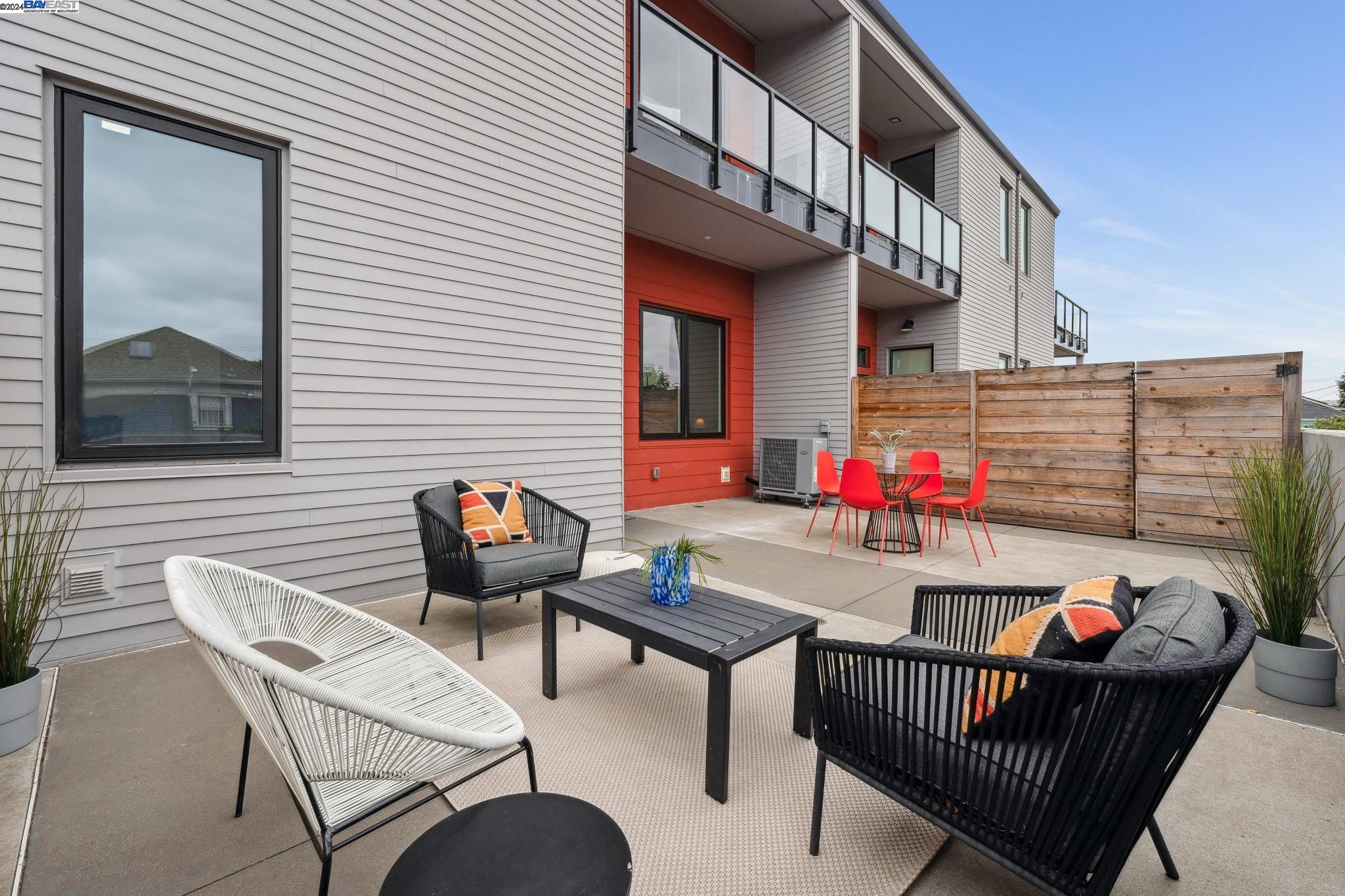 a view of a chairs and table in the back yard of the house