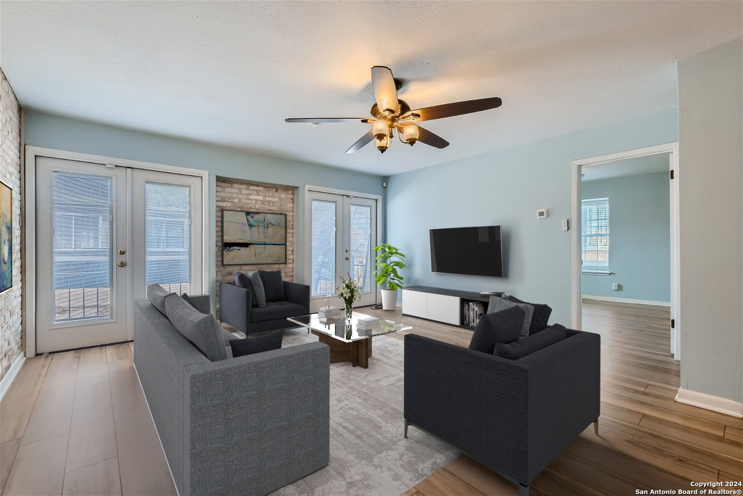 a living room with furniture and a flat screen tv