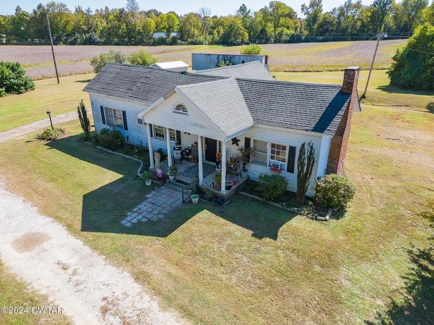 View of front of home with a front lawn, a rural view, and a patio area