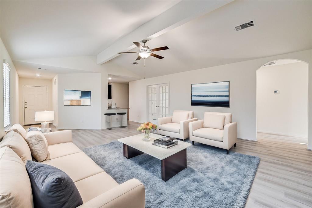 a living room with furniture rug and wooden floor