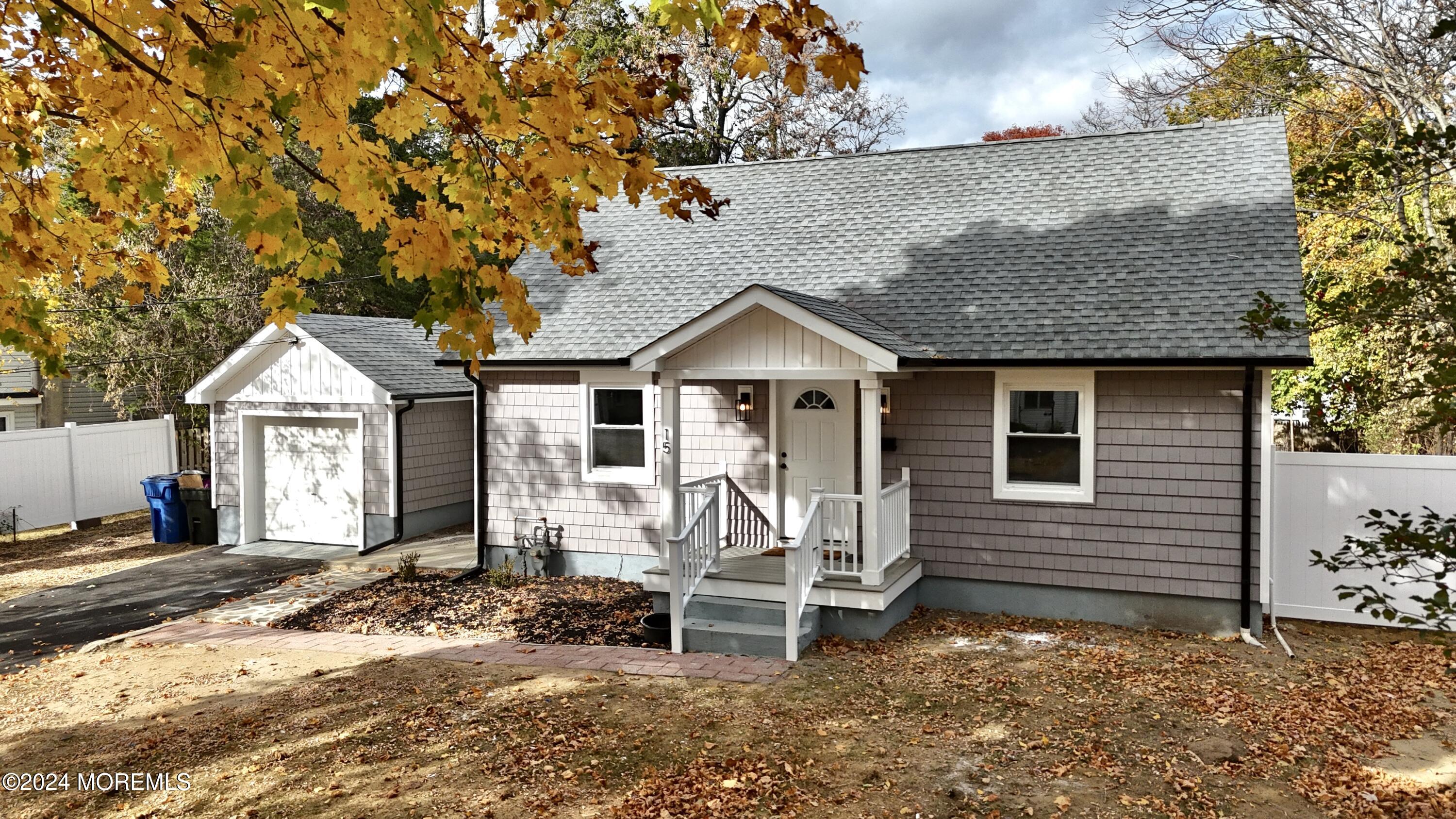 a view of a house with wooden fence next to a house