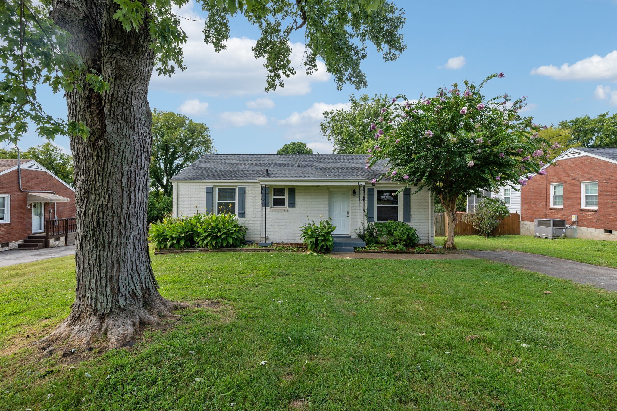 a front view of a house with a garden