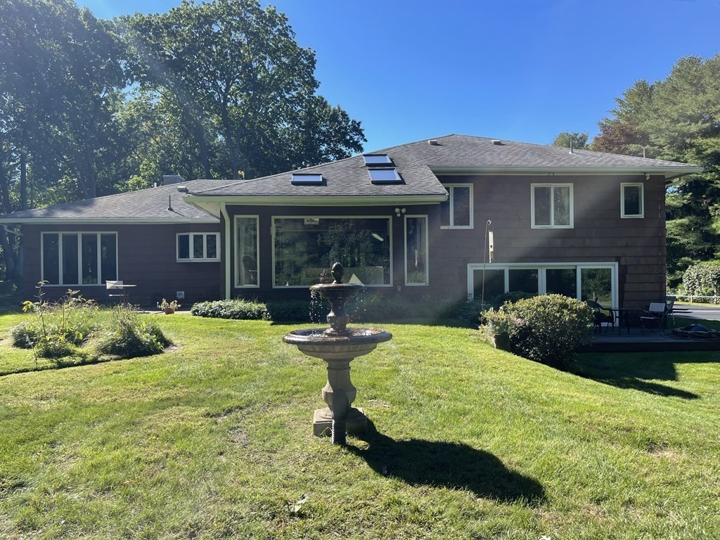 a view of a house with pool and chairs